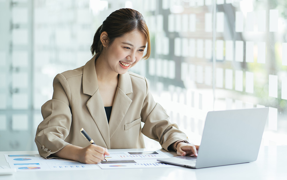 A woman does financial work on a computer