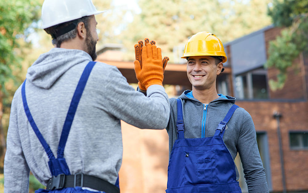 Construction workers give each other a high five