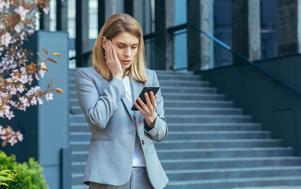 A business woman reads bad news