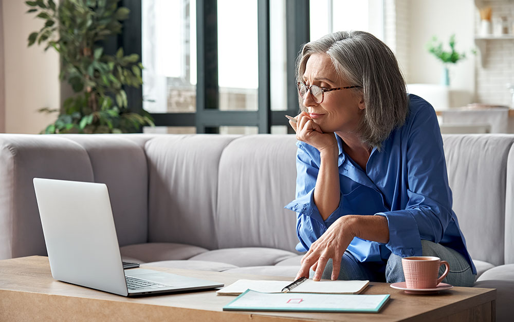 A woman looks at her computer