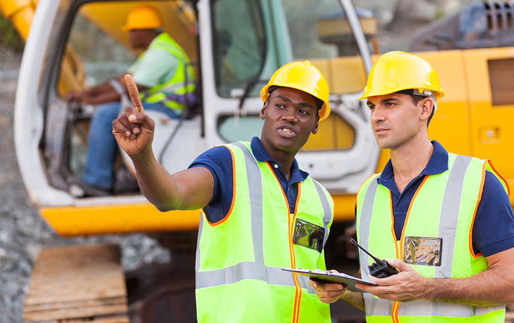 Construction workers communicate on a job site