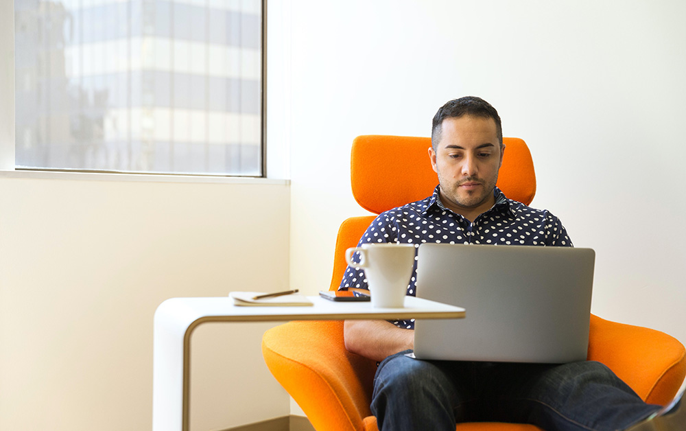 Man works on his laptop