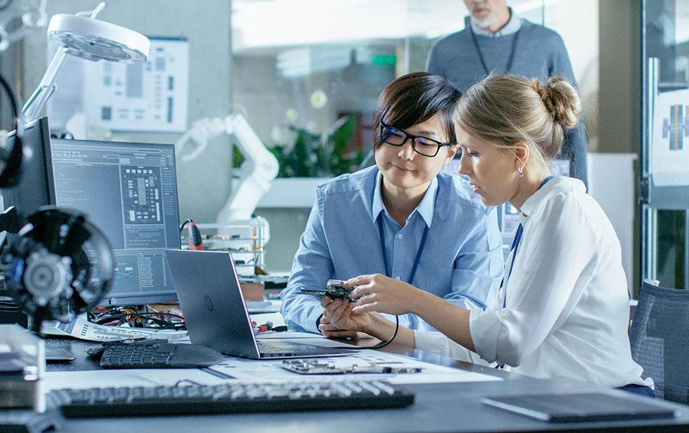 Engineers work at a desk