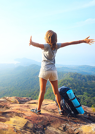 Woman rejoices at cliff