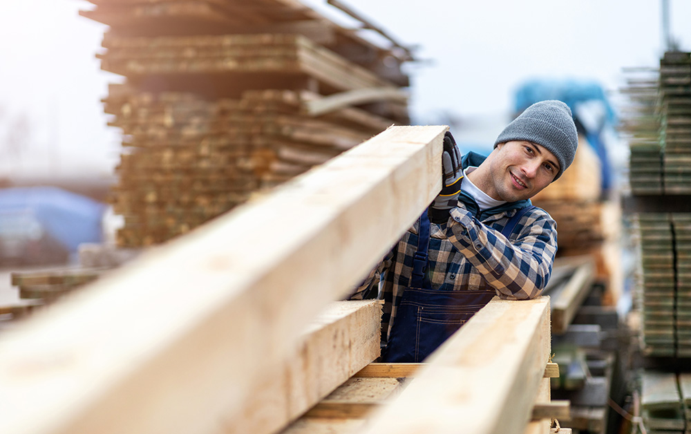 A man works in a lumber yard