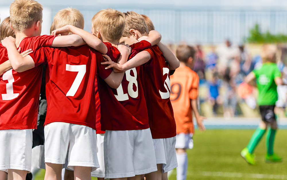 Youth athletes in a huddle